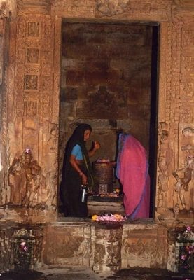 Puja performed by two women before the lingam at the Duladeo temple, Khajuraho, (2000).